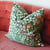 Floral print pillow on a pink sofa