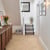 Van Gogh Canadian Nude Oak herringbone mid brown LVT flooring laid in a hallway.