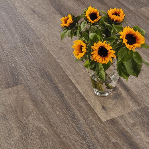 Baltic Mistral Oak grey LVT flooring laid straight with some flowers on top
