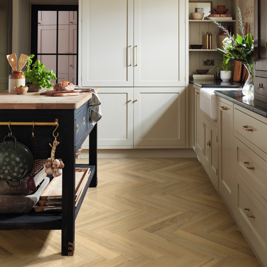 Wells Acacia light brown herringbone LVT flooring in a kitchen